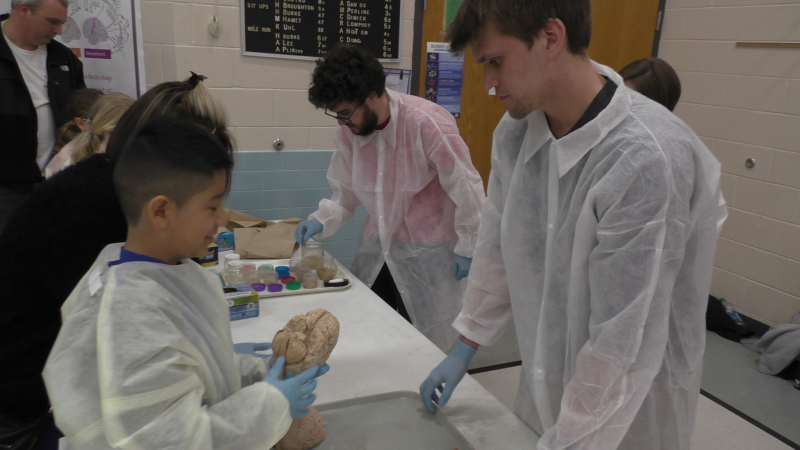 Picture of student doing science demonstration Picture of student doing science demonstration