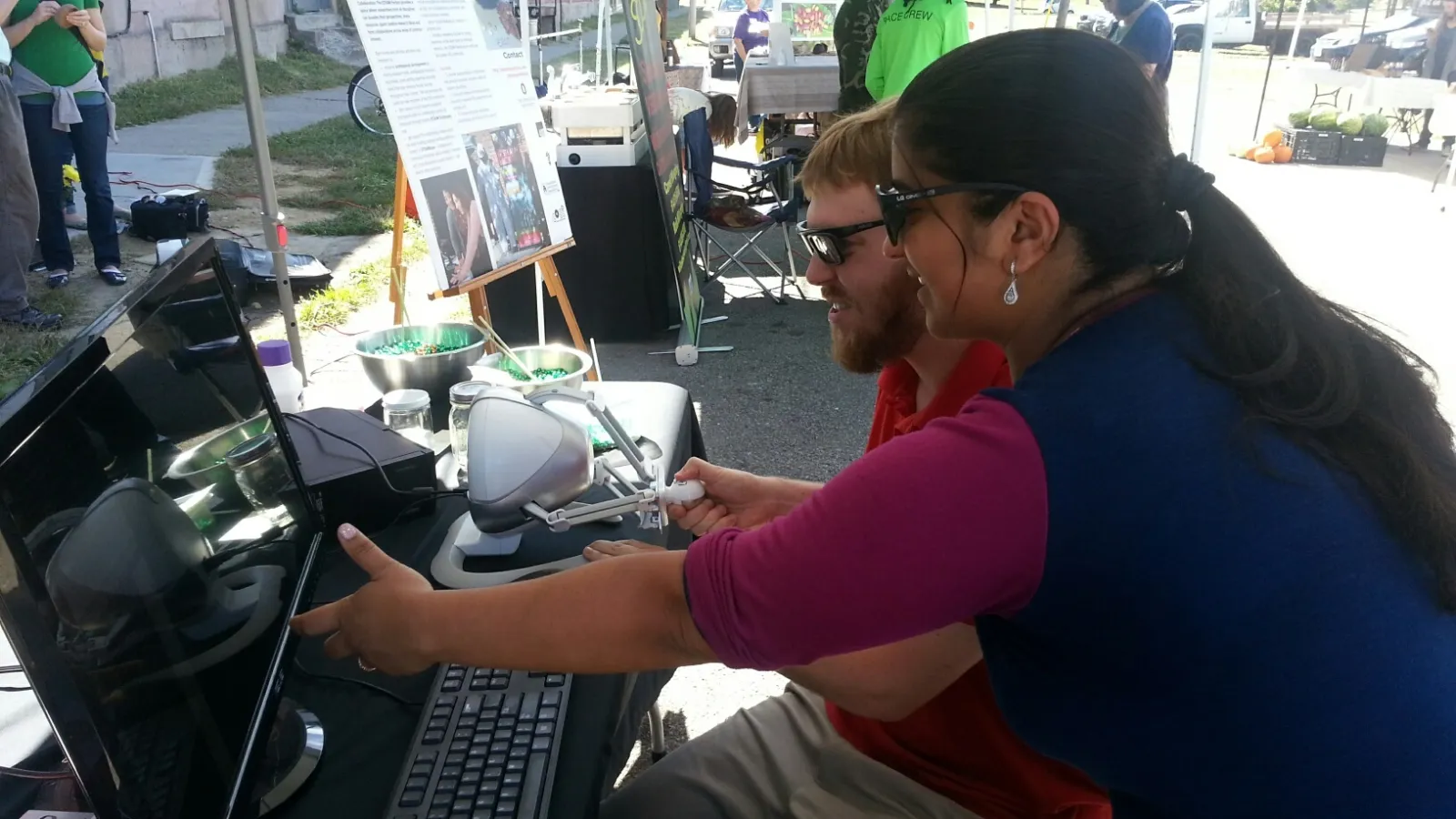 STEAM member pointing at computer screen at a 400 W. Rich Market