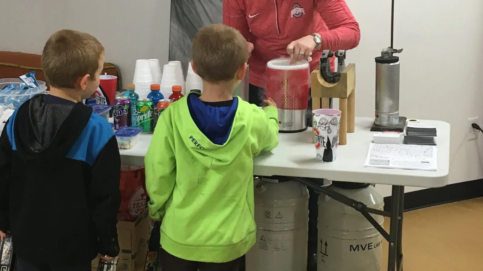 Presenter and children experiment with liquid nitrogen