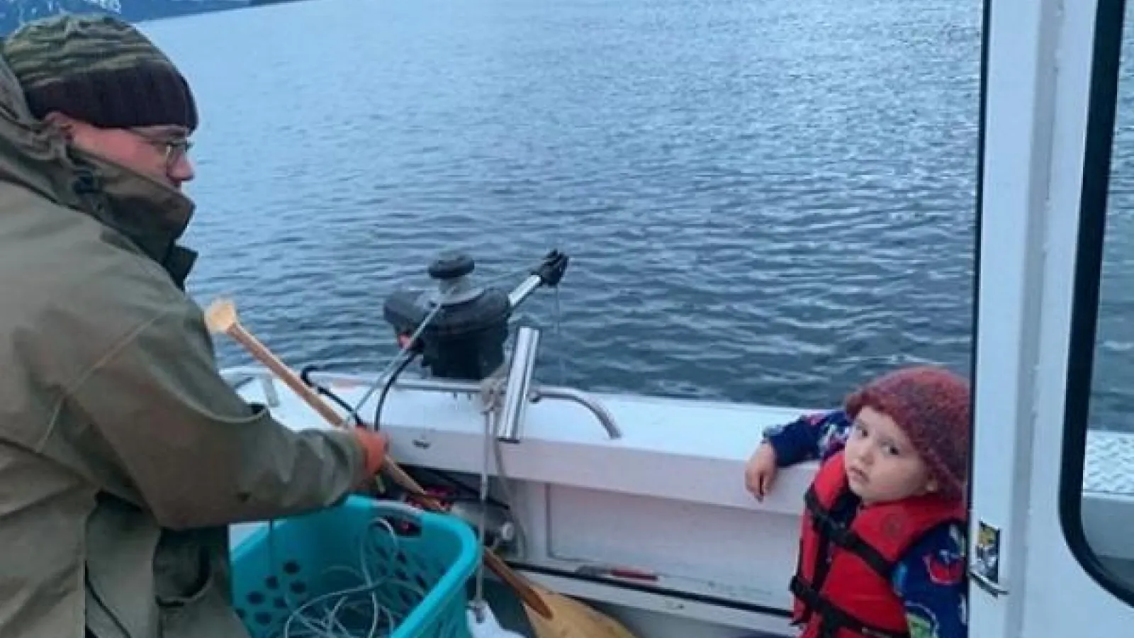 man and child on a boat overlooking a lake
