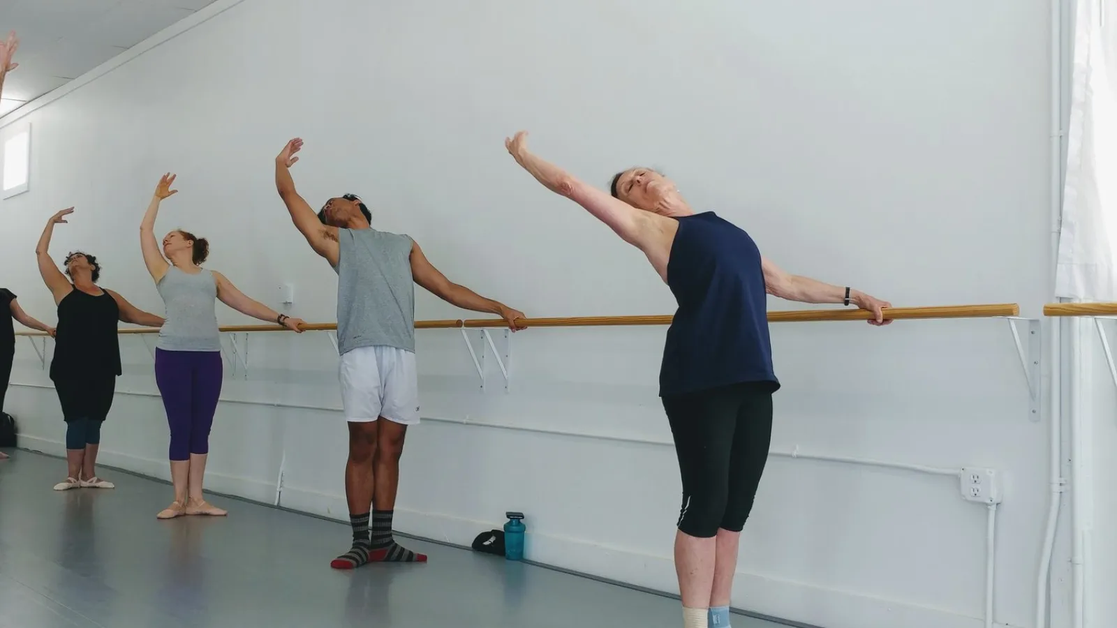 five people preparing to dance
