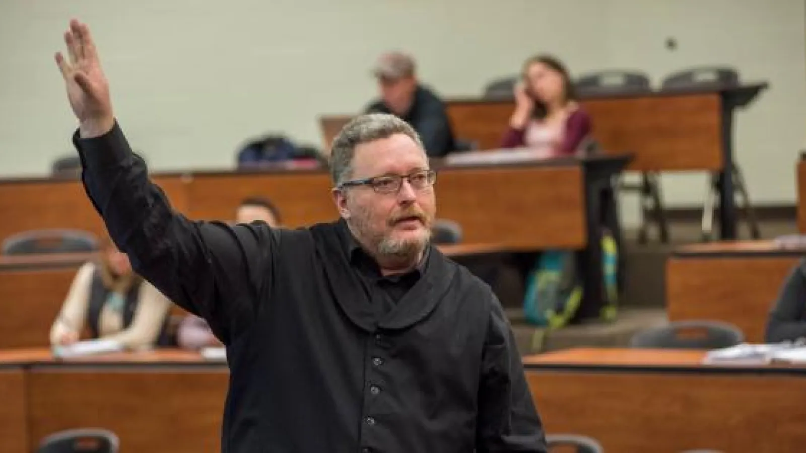 Man teaching a lecture in a college classroom