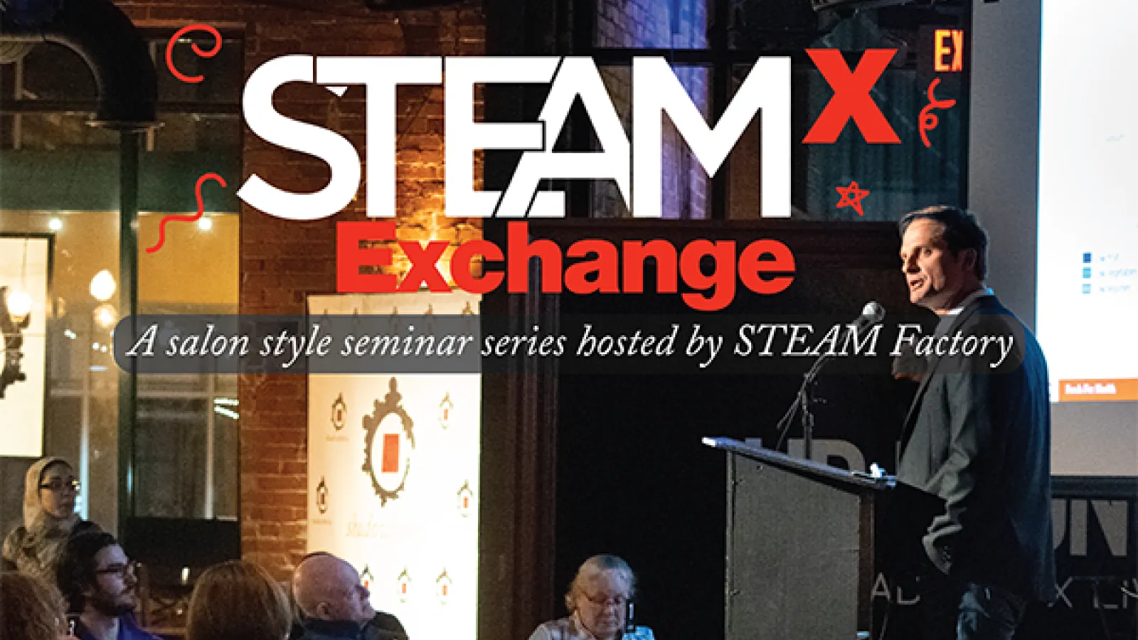 A picture of a Steam Exchange with a speaker talking to an audience