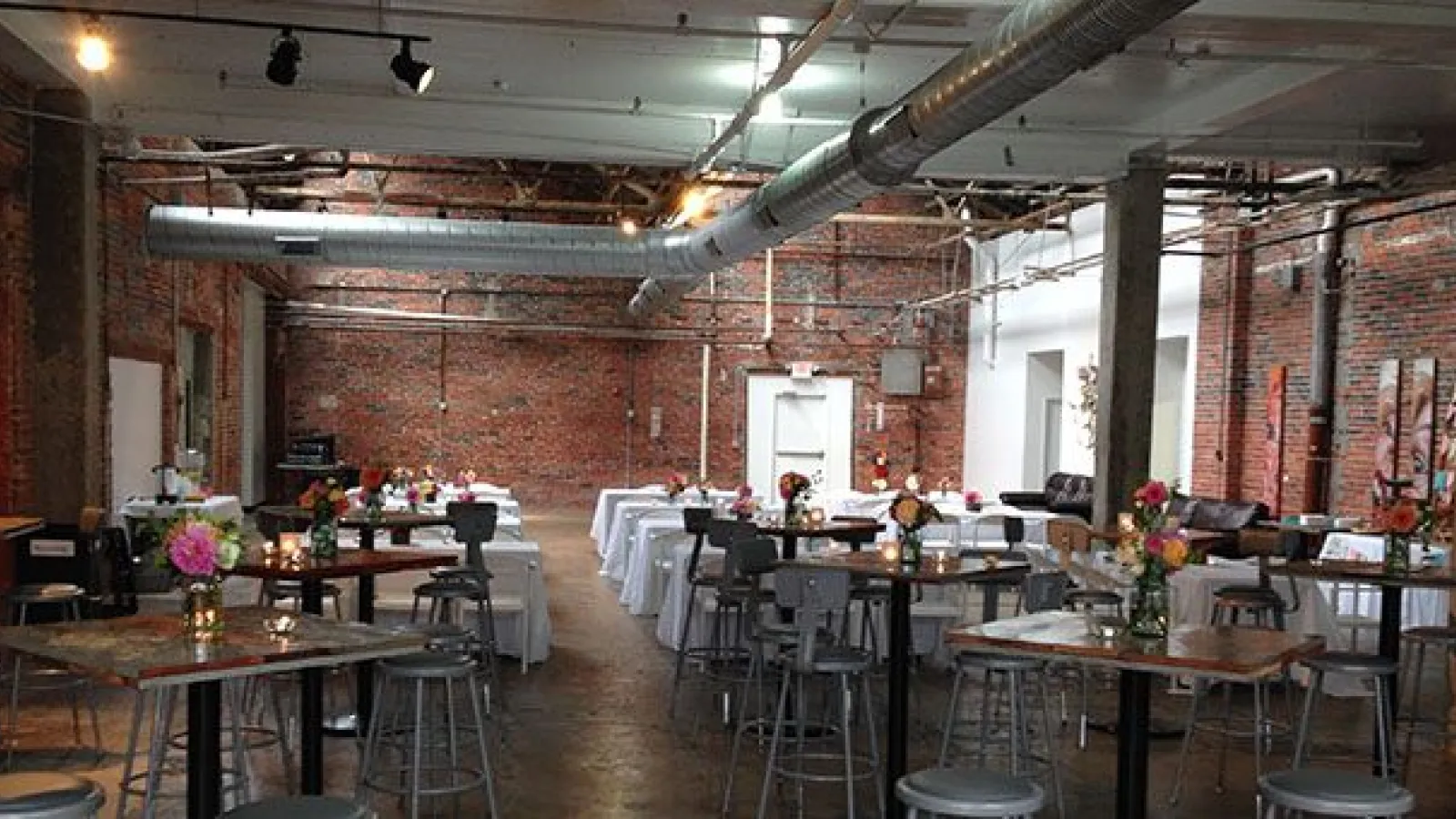 An interior photo of Strongwater with tables, chairs and windows
