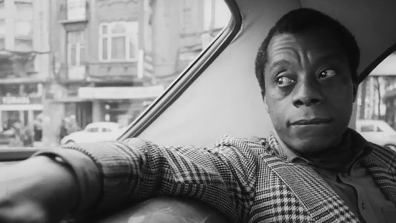 James Baldwin riding in a vehicle