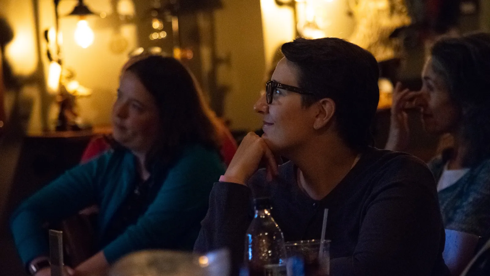 women staring at the Backstage Bistro stage and smiling