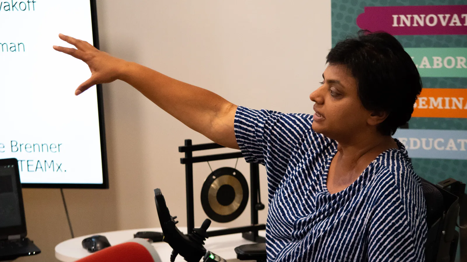 STEAM Member Sathya Gopalakrishnan pointing towards a presentation