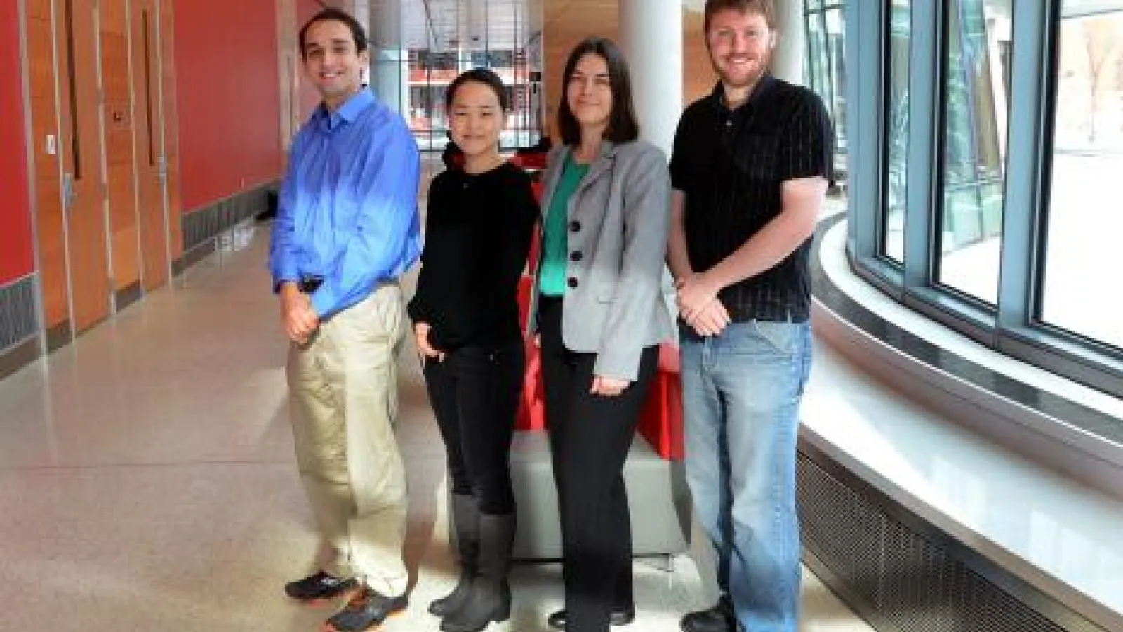 Assistant Professor Lisa Hall (grey jacket) with members of her research group (from left) Alex Trazkovich, Youngmi Seo and Jon Brown (photo: Geoffrey Hulse).