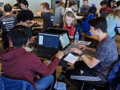 Students working on their laptops in groups