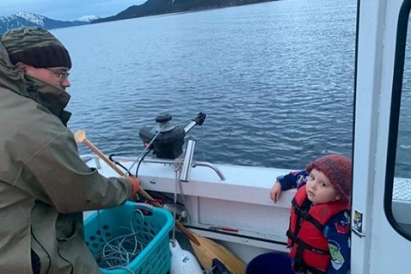 man and child on a boat overlooking a lake