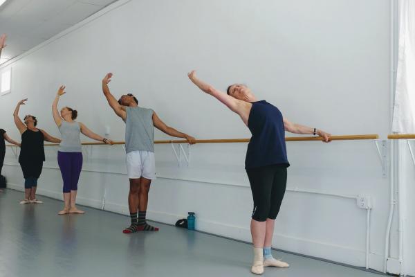 five people preparing to dance