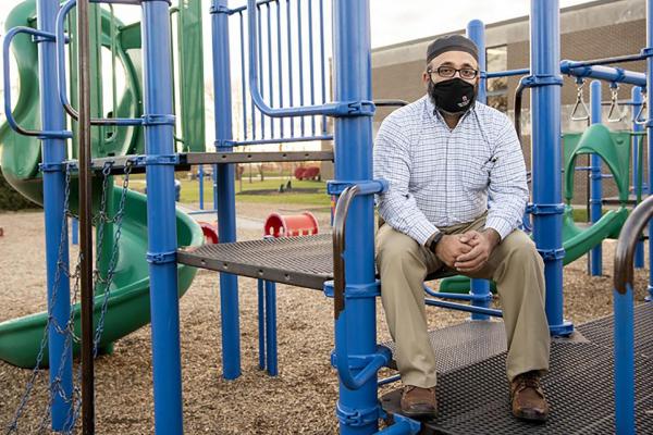 Ayaz Hyder sitting at a playground