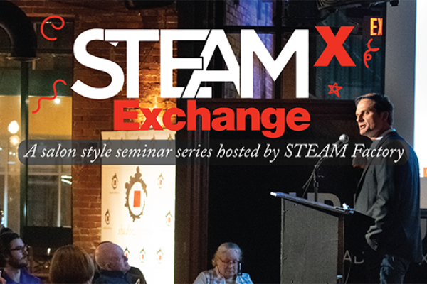 A picture of a Steam Exchange with a speaker talking to an audience