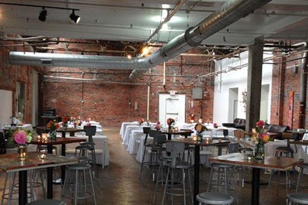 An interior photo of Strongwater with tables, chairs and windows