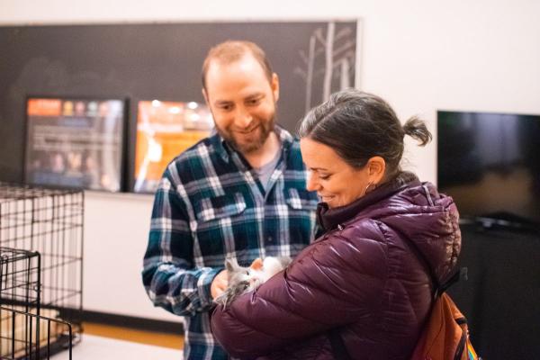 Image of people and kitten from event