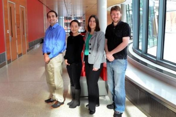 Assistant Professor Lisa Hall (grey jacket) with members of her research group (from left) Alex Trazkovich, Youngmi Seo and Jon Brown (photo: Geoffrey Hulse).