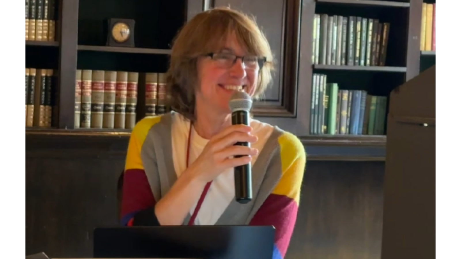 Woman seated with microphone