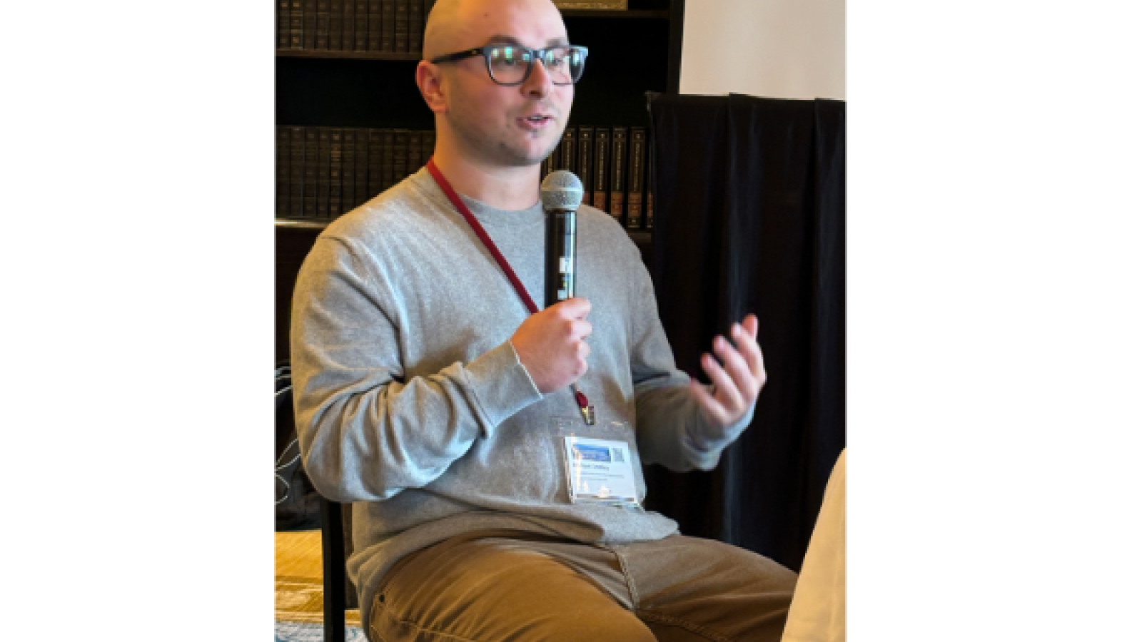 Man seated with microphone