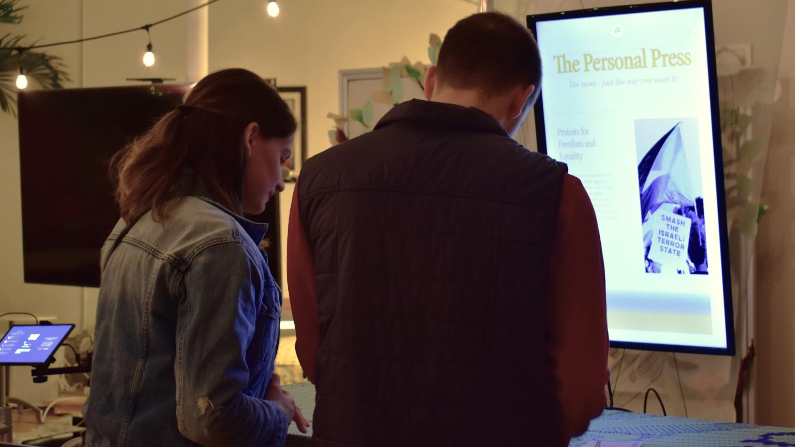 two people reading exhibit page