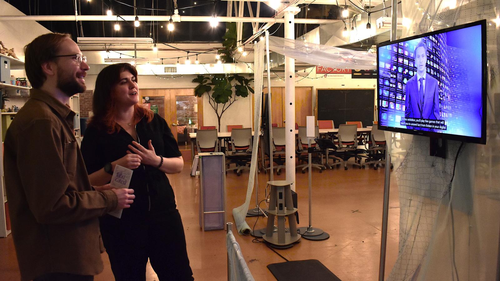 two people looking at exhibit screen